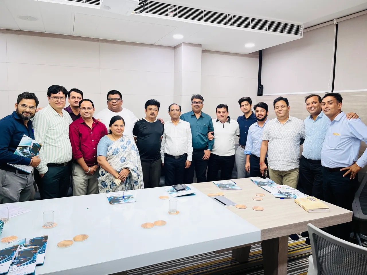 SWIL colleagues together in a Jaipur HQ meeting room behind a conference table.